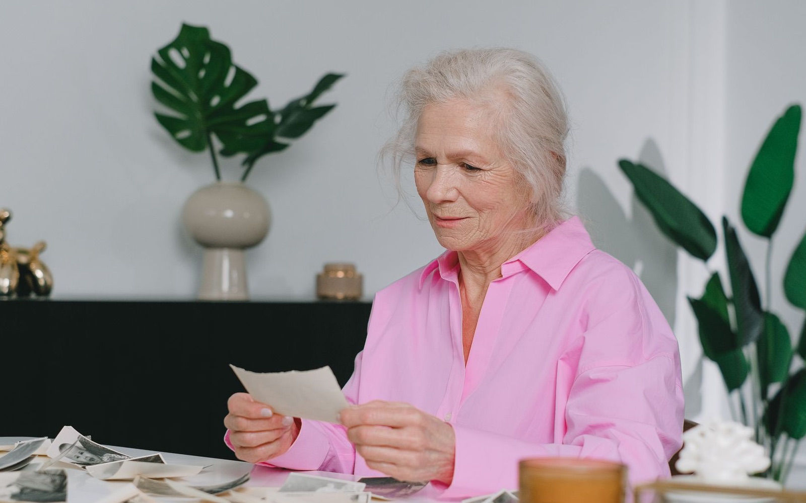 A senior woman revisiting an old family photograph